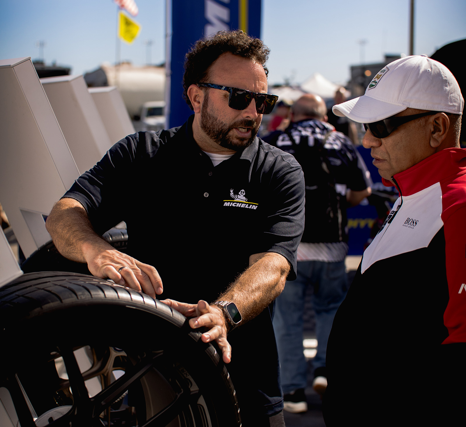 Two men discussing tire tread technology